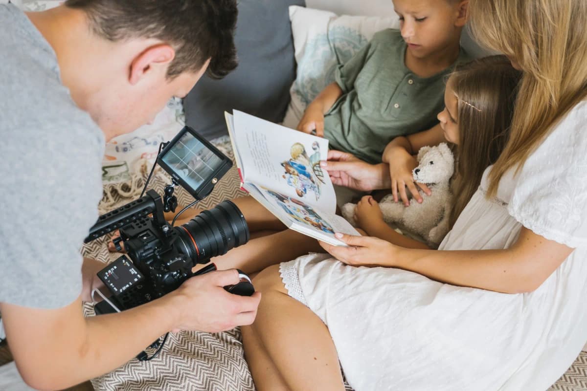 Representative stock photograph of a photographer taking an indoor family photo with a camera